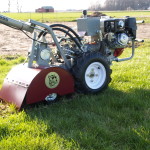 tilling spring sod to prepare for a summer garden with a POWER DOG tiller